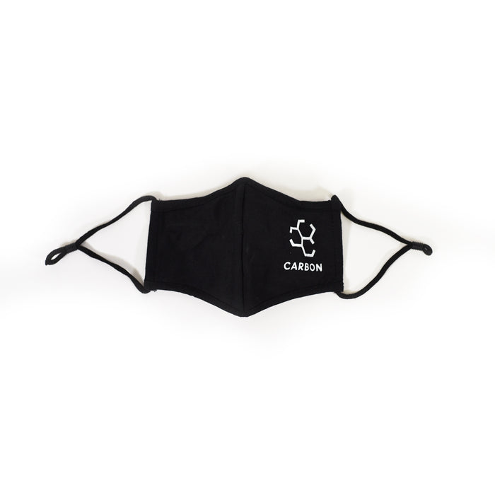 Carbon black streetwear face mask with white logo, featuring adjustable ear loop toggles on a white background.
