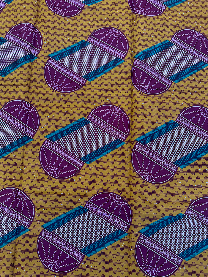 African Patterned fabric with purple and blue shapes on a brown background