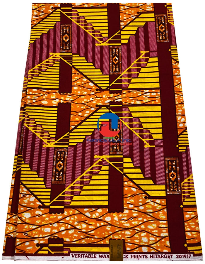 A piece of fabric with geometric wax print in burnt-orange, yellow, red, white, and burgundy colors.