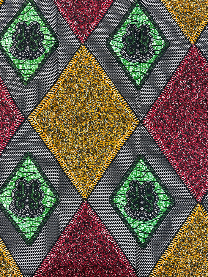 Patterned fabric with geometric design featuring green, gold, and red colors.