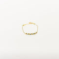 Dainty gold chain anklet featuring blue and white beaded charms on a minimalist adjustable link strand.