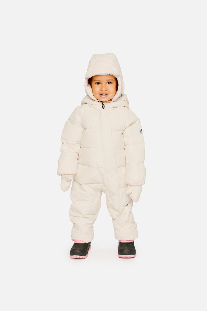 Baby standing in the off-white Deux par Deux Baby Cloud snowsuit, front view
