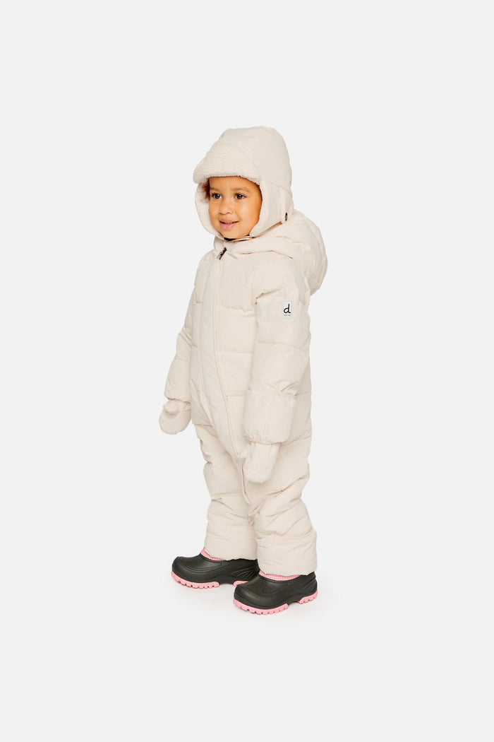 Side view of a baby wearing the off-white Baby Cloud one-piece snowsuit