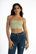 Model in Bailey sage green ribbed crop tank top with spaghetti straps and dark wash distressed denim jeans.