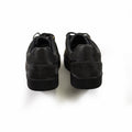 Rear view of black Camel Flush sneakers for men featuring carbon camouflage texture and textured streetwear soles.