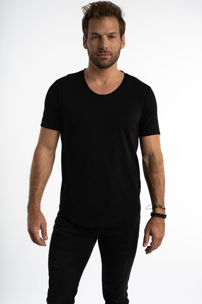 Man wearing a black Carbon Classic Streetwear Tee with a scoop neck, curved hem, and short sleeves.