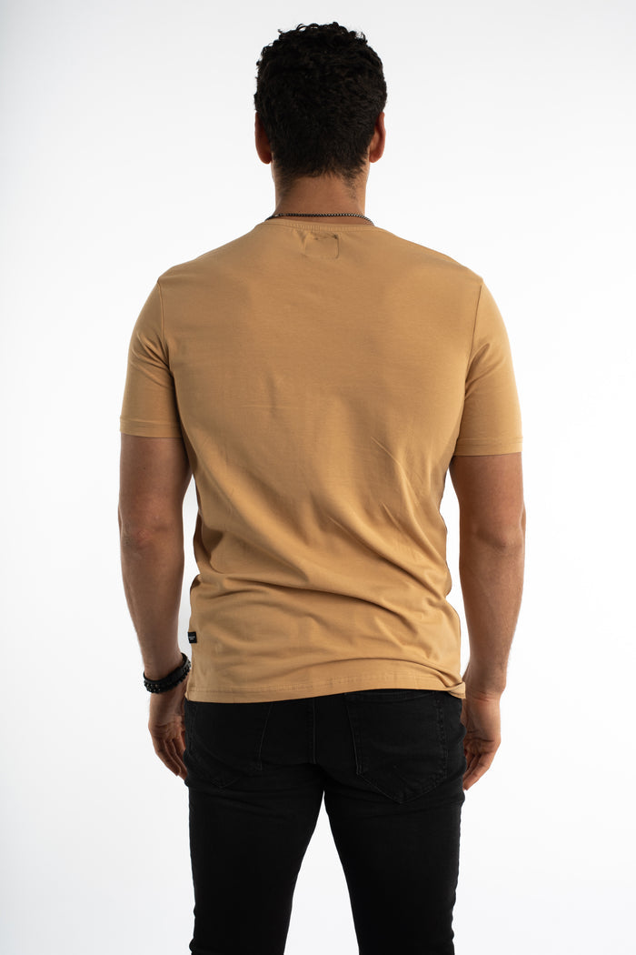 Back view of the Urban Horizon Graphic Tee in Mink, a slim-fit men's streetwear t-shirt paired with black jeans.