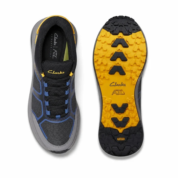Pair of black trail low sneakers with blue uppers and yellow outsole tread