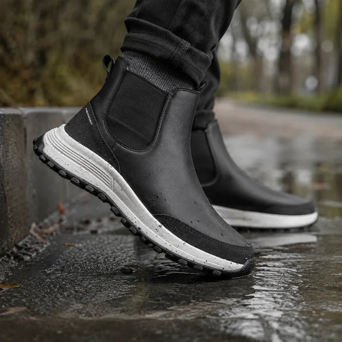 Black leather ankle boots with elastic gore panel and textured white outsole