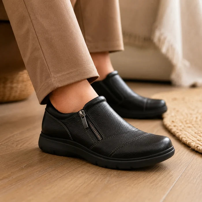 Women's black leather casual shoes with zip front and thick cushioned sole