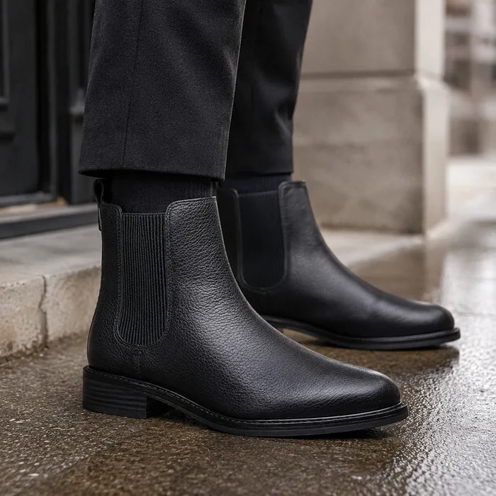Women's black leather Chelsea boots close-up with elastic side gore and low block heel