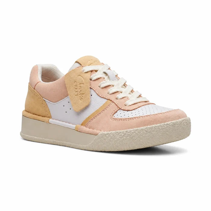 Women’s sneakers in pale peach, white, and tan with lace-up and padded collar
