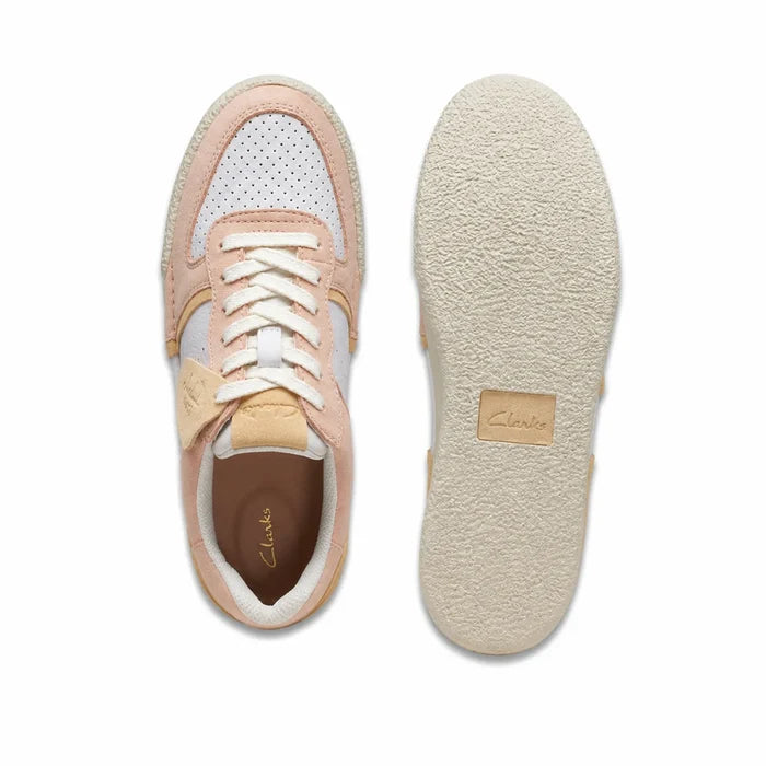 Women’s sneakers pair, pale peach and white upper with lace-up and tan heel panel