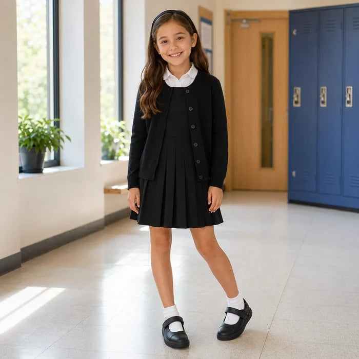 Kids black loafers worn with white socks and a black school dress.