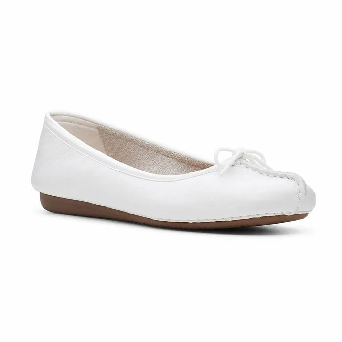 Women’s white leather ballet flat with lace tie and low brown rubber sole.