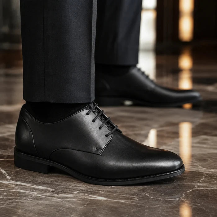 Black leather lace-up dress shoes, plain toe and low-profile sole