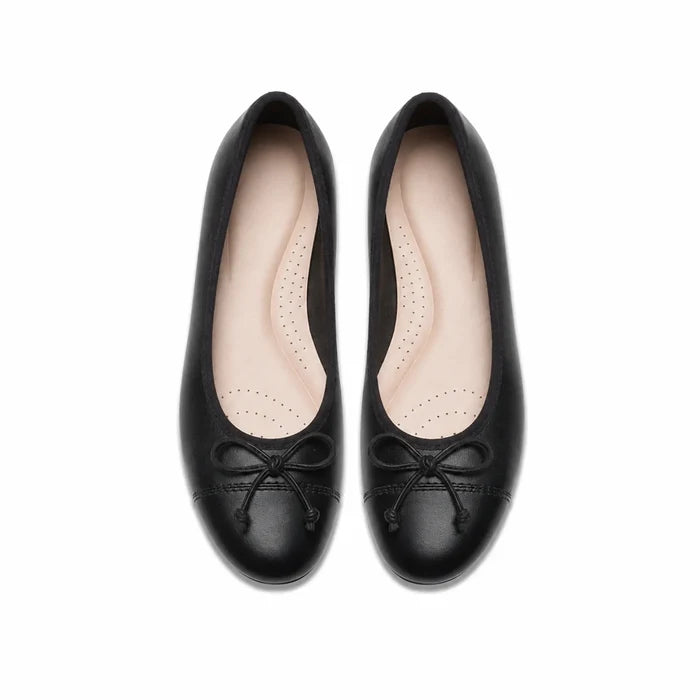Pair of black leather ballerina flats with lace bow and perforated insole