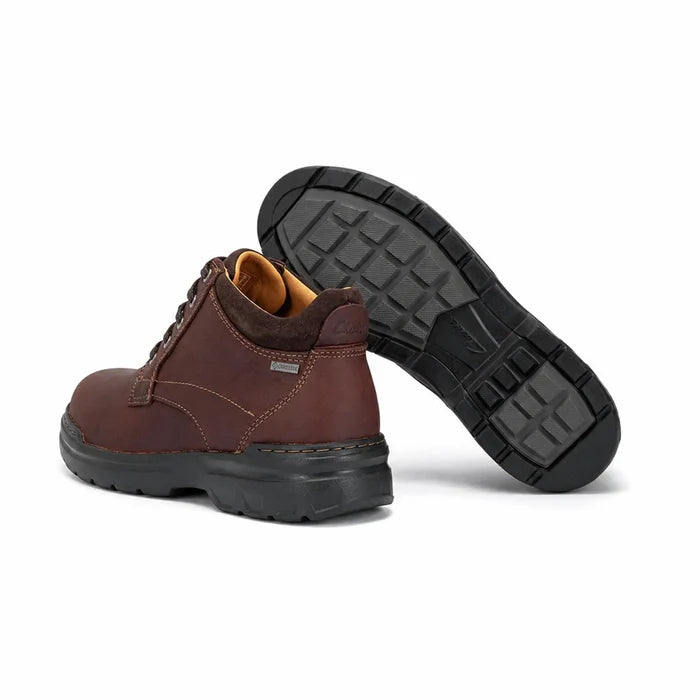 Men's brown leather ankle boots, heel and outsole tread view, dark rubber