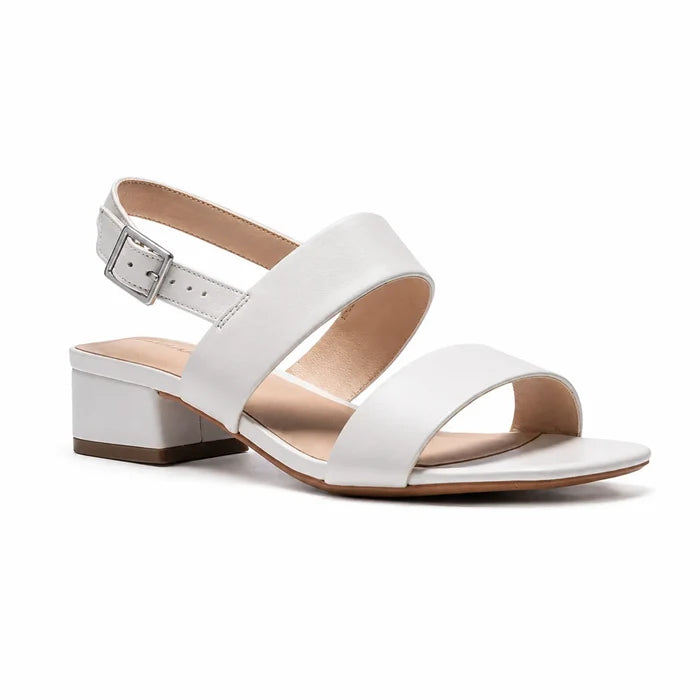 White leather strap sandals with ankle buckle and low block heel, side view