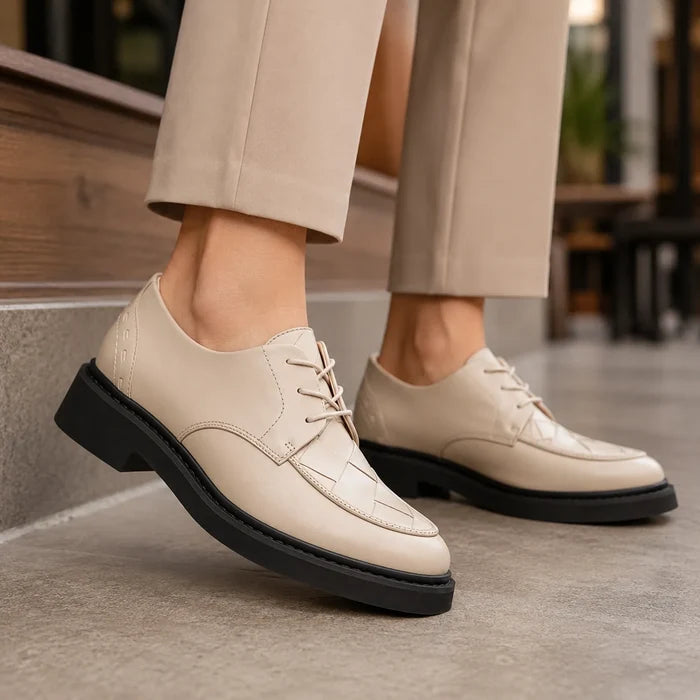 Pair of women’s white leather lace-up business shoes with chunky black platform sole