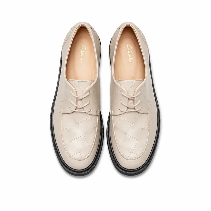 Women’s white leather lace-up business shoes, two-quarter view showing black sole trim