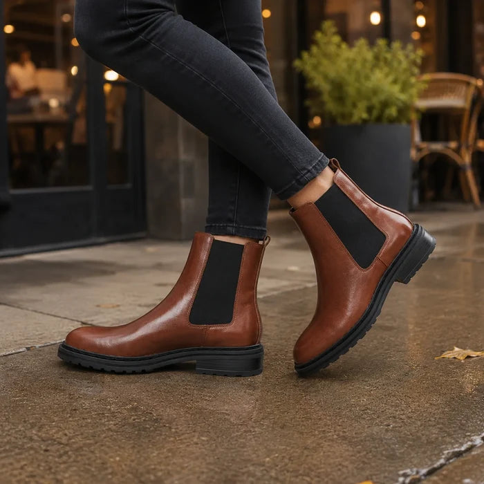 Brown Chelsea boots with elastic side panels and dark rubber sole