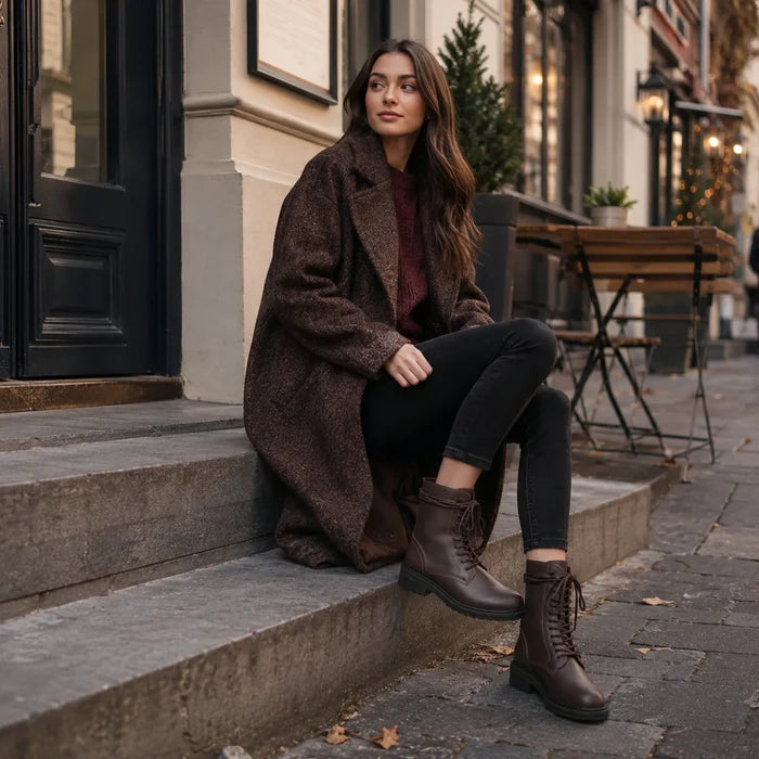 Brown leather lace-up ankle boots with thick sole and ankle-high shaft.
