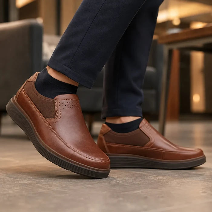 Brown leather slip-on shoe with perforated toe and side goring, thick rubber sole