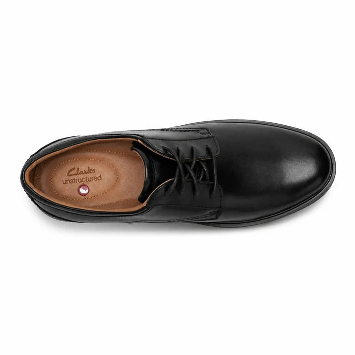 Black leather lace-up business shoe with tan interior lining and low profile sole.
