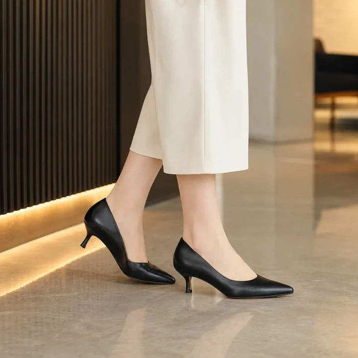 Women's black heeled court shoes, side view with pointed toe and slim heel