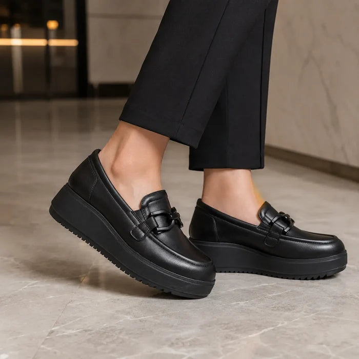 Black leather platform loafers with front strap and textured rubber sole