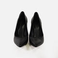 Pair of sleek black carbon pointed-toe stiletto pumps, high-angle front view on white background.