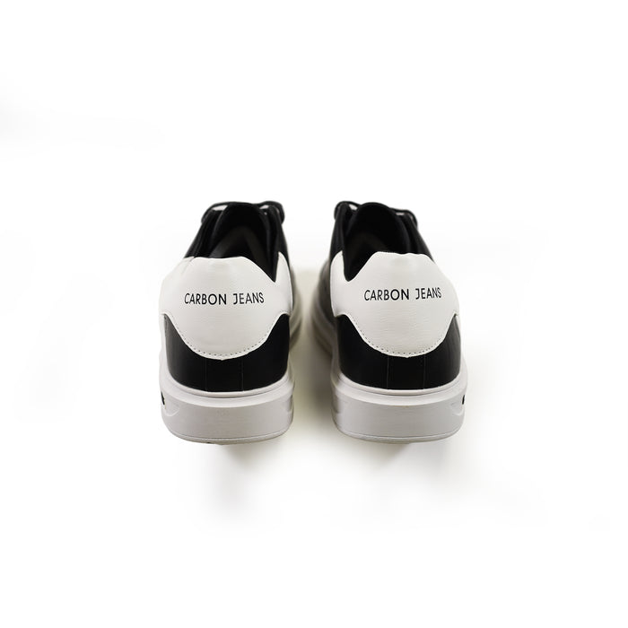 Heel view of Carbon Jeans black and white low-top sneakers featuring minimalist logo on white background.