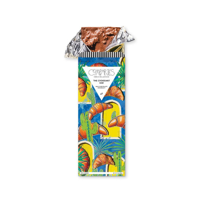 Croissant chocolate bar in gold foil and colorful packaging.