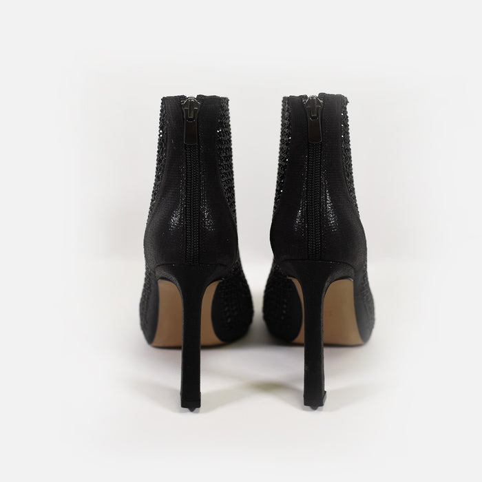 Rear view of Carbon black rhinestone stiletto heels featuring shimmering mesh accents and back zipper closures.