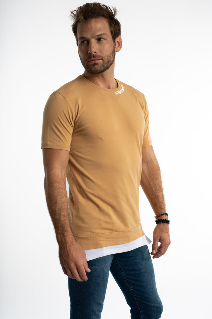 Man wearing The Different Tee in Carbon Mink with white collar embroidery and a layered hem streetwear fit.