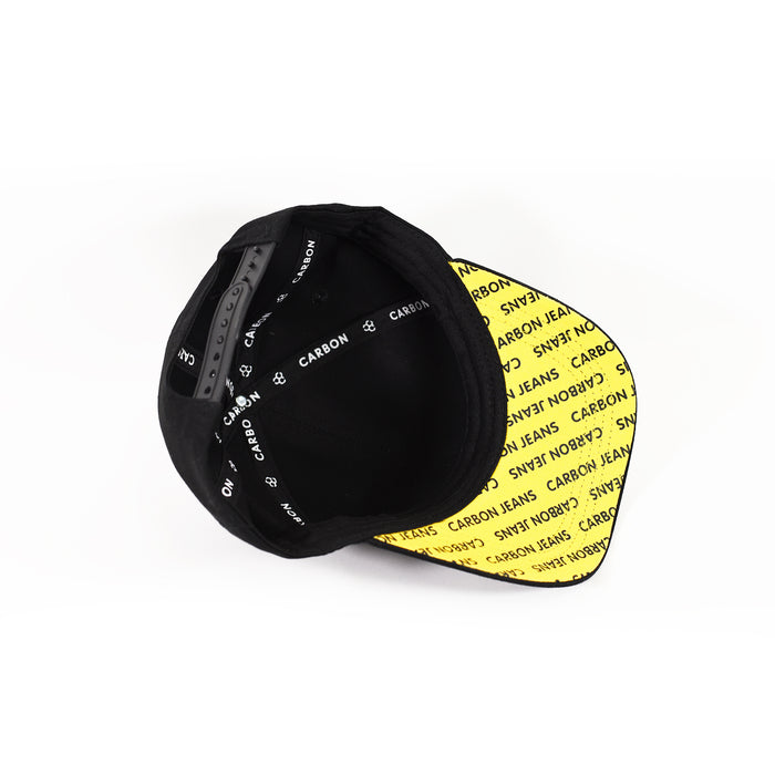 Interior of black Don't Care trucker hat with yellow printed under-brim, Carbon logo taping, and adjustable snapback.