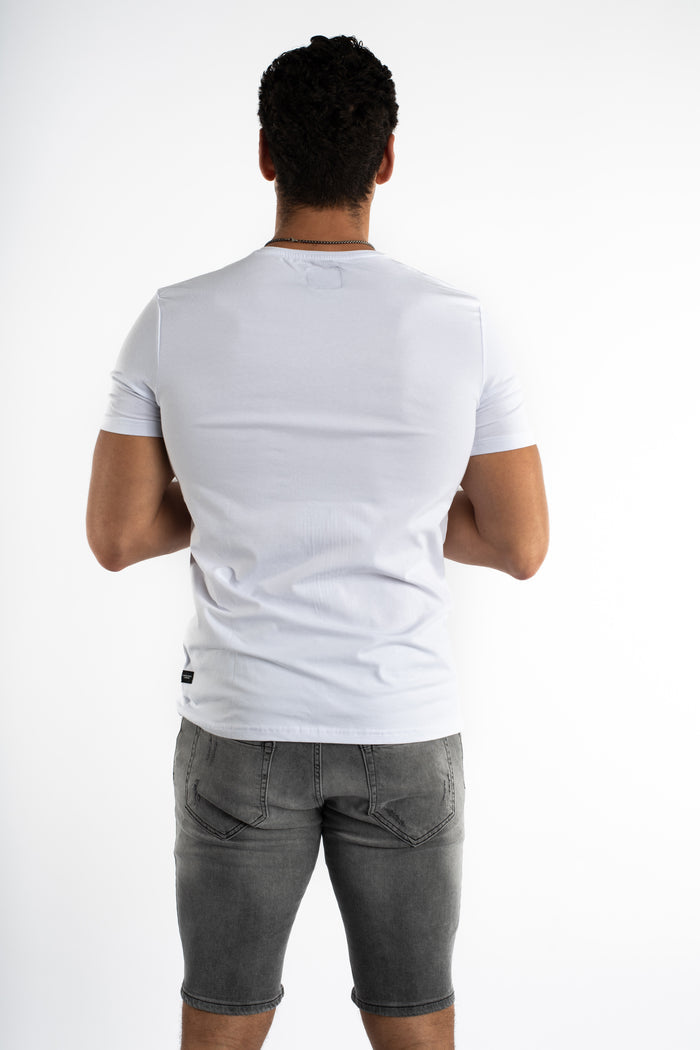 Back view of Carbon's white streetwear graphic tee in a slim fit, styled with grey denim shorts for an urban look.