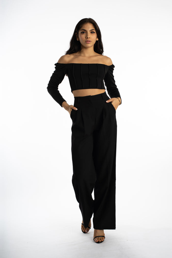 Model in Dulce black off-the-shoulder bodysuit with corset ribbing and matching wide-leg trousers streetwear.