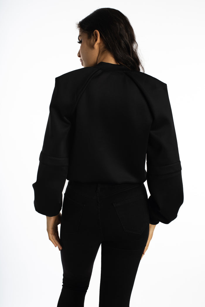 Back view of the Ellis Bomber Jacket in Carbon black, featuring padded shoulders and oversized streetwear sleeves.