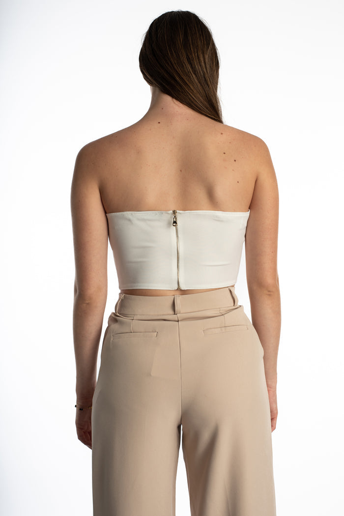 Back view of the white Emmie Strapless Bustier corset top featuring a gold-toned zipper closure and cropped fit.