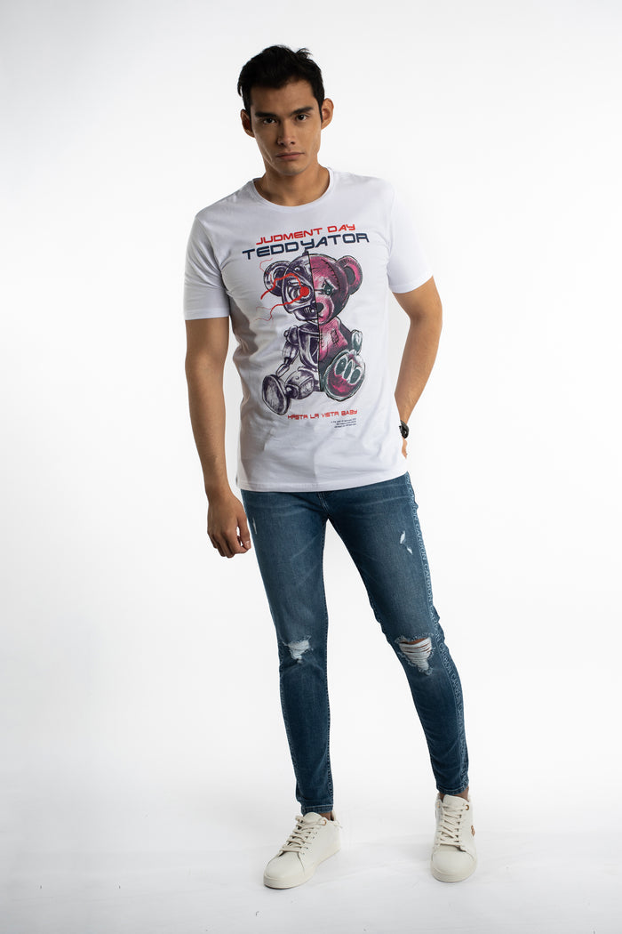 Men's Finnley blue slim fit distressed jeans with Carbon side logo tape and ripped knees on a studio model.