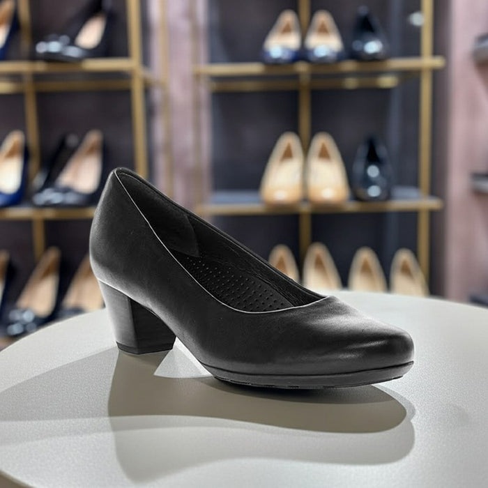 Women’s black leather closed-toe pump, 3/4 profile with low block heel