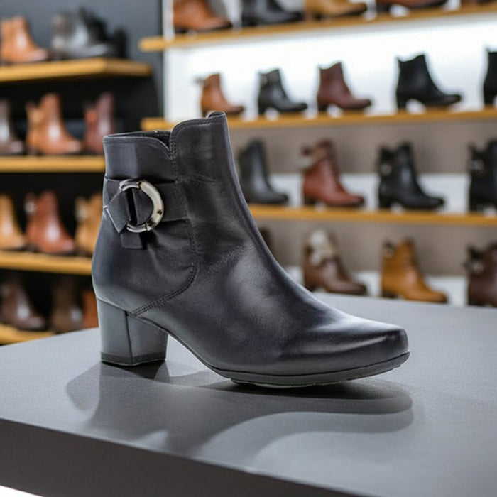 Women’s black leather heeled ankle boots with buckle strap on the shaft