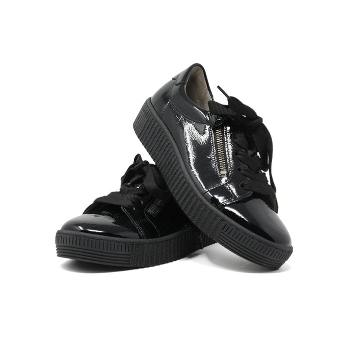 Black glossy low-top sneakers with lace-up and zipper detail, pair view.