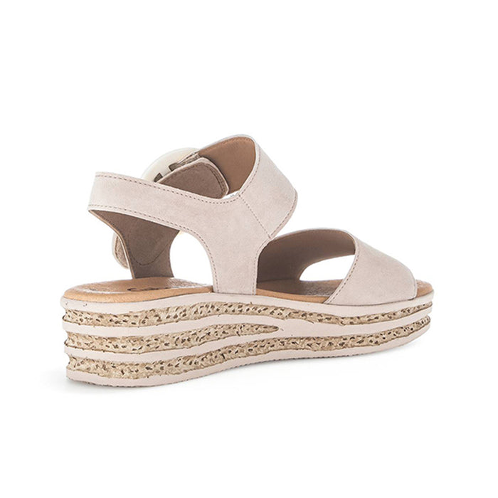 Beige open-toe platform sandals with wide cross straps and cork-textured sole