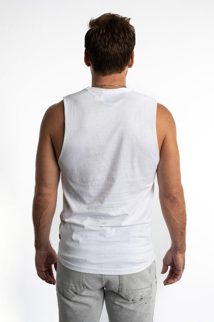 Back view of a man in the Good Things white streetwear tank and grey pants, highlighting the clean fit and ribbed texture.
