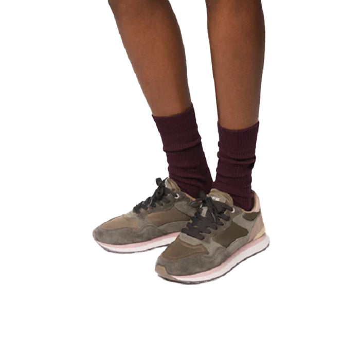 Women’s green lace-up sneakers worn with maroon socks