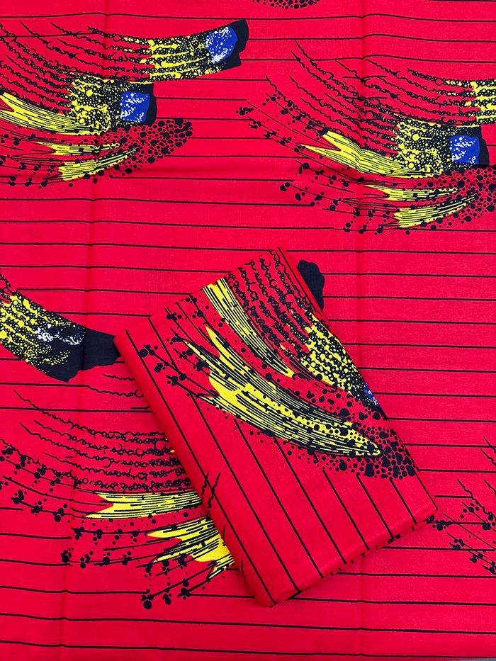 African Red fabric with black and yellow patterns on a red background