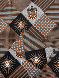 Hollandais Wax Print Fabric with geometric designs in brown, white, and black on a white background